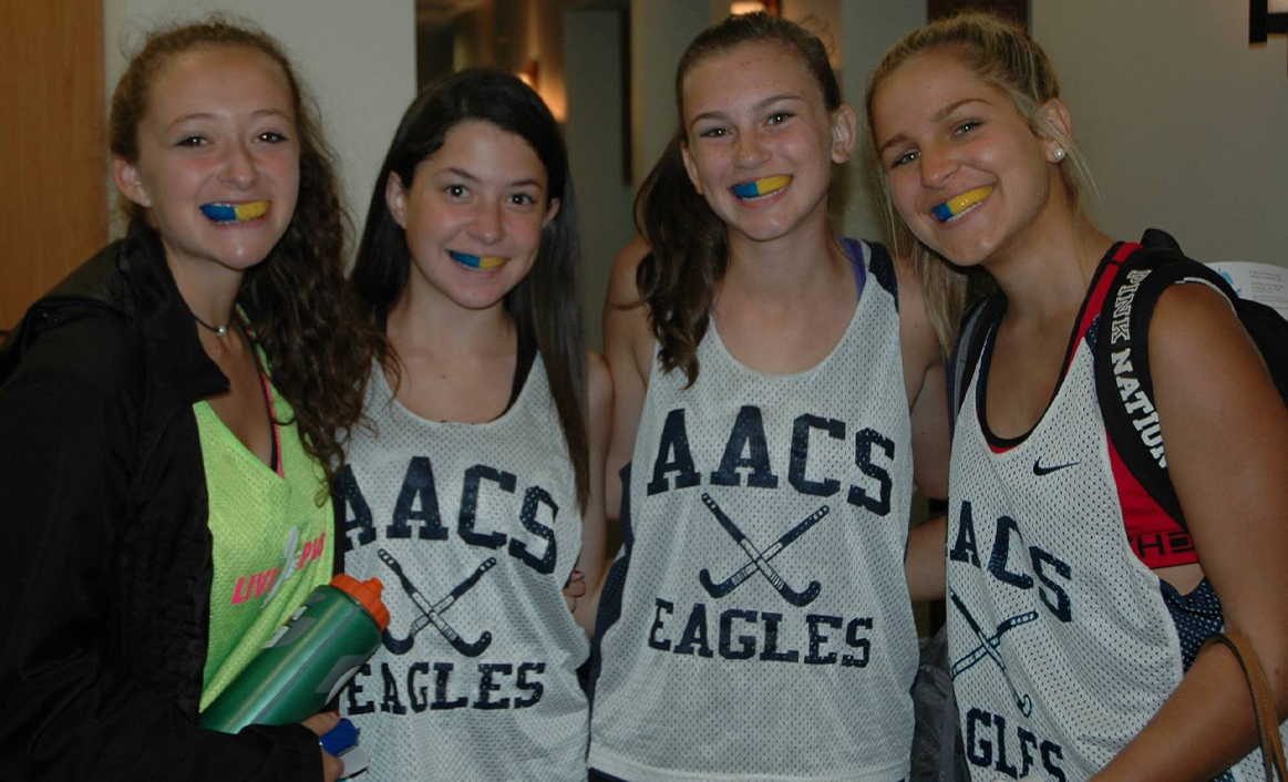 lacrosse girls smiling with mouthguards