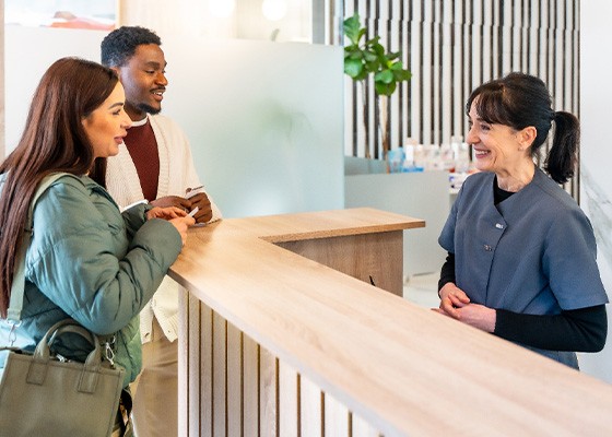 Couple discussing the cost of root canal treatment in Annapolis with staff member