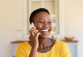 Woman smiling while talking on phone
