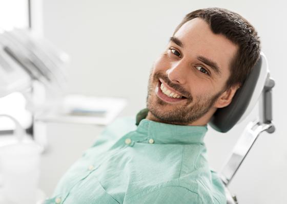 man laying back at exam chair