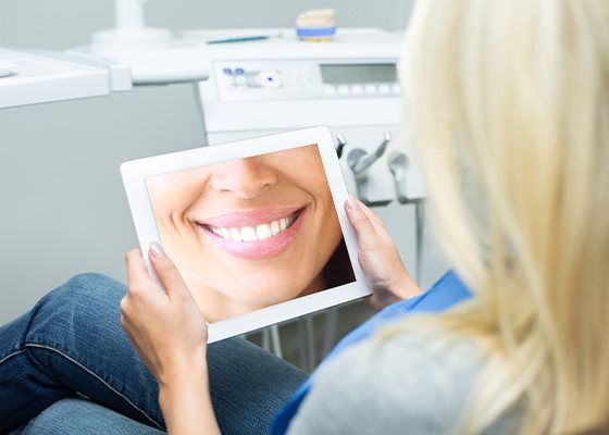 woman looking at smile on ipad