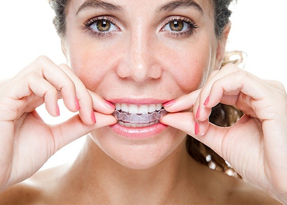 woman putting in invisalign