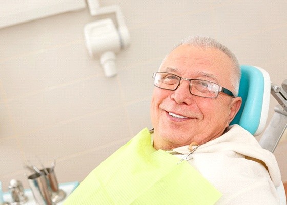 smiling man sittting in a dental chair