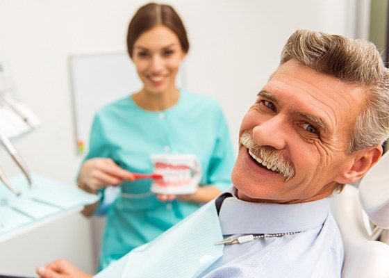 man with mustache smiling at camera