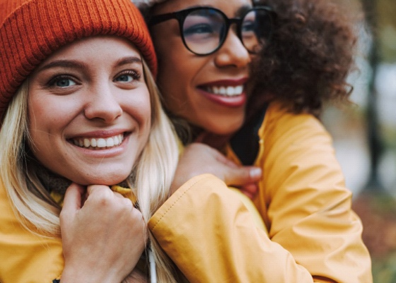 Closeup of two friends smiling together on hike