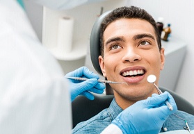 a person receiving a checkup and cleaning from their dentist