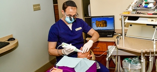 dentist working with impression system