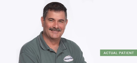 Smiling Annapolis dental patient in green polo shirt