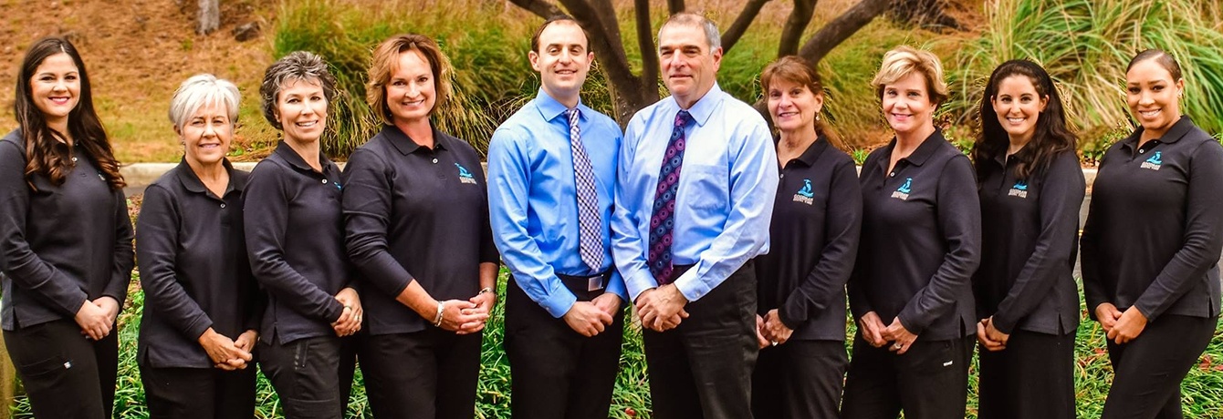 Annapolis dentists and team members smiling outdoors