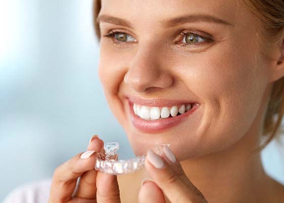 Woman with beautiful teeth thanks to Invisalign in Annapolis