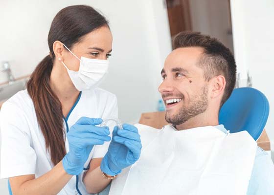 Dentist and patient discuss how much does Invisalign cost in Annapolis