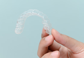 Patient holding clear aligner