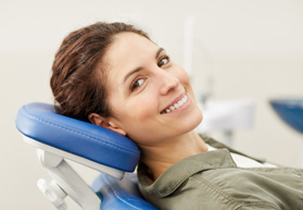 Woman smiling while sitting in treatment chair