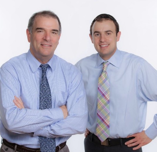 A photo of Dr. A Gary Goodman and Dr. Jeremy Goodman smiling