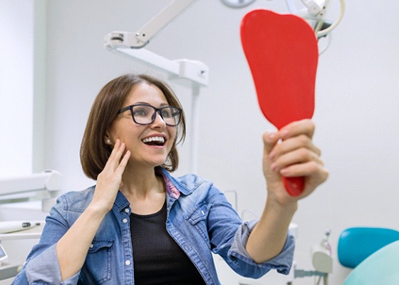 Young woman admiring the results of her smile makeover in Annapolis