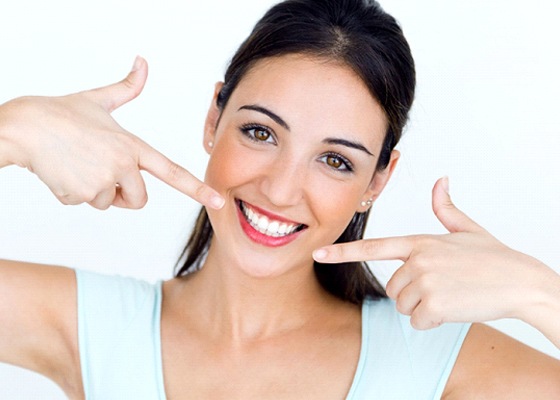 woman pointing to her white smile