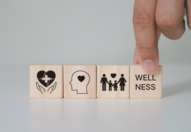 Wooden blocks that say “wellness” 