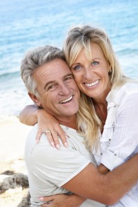Smiling middle aged couple at the beach