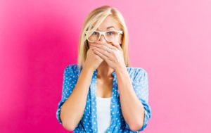 woman hiding teeth