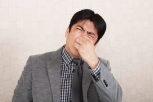 man covering nose from bad smell