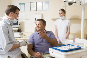 Smiling man talking to dentist