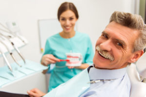 Older man with dentures smiling