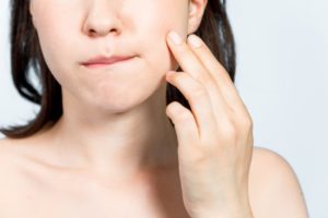 woman holding jaw from pain