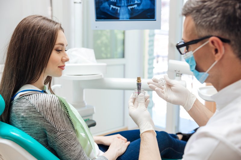 A dentist explaining how implants preserve your jawbone