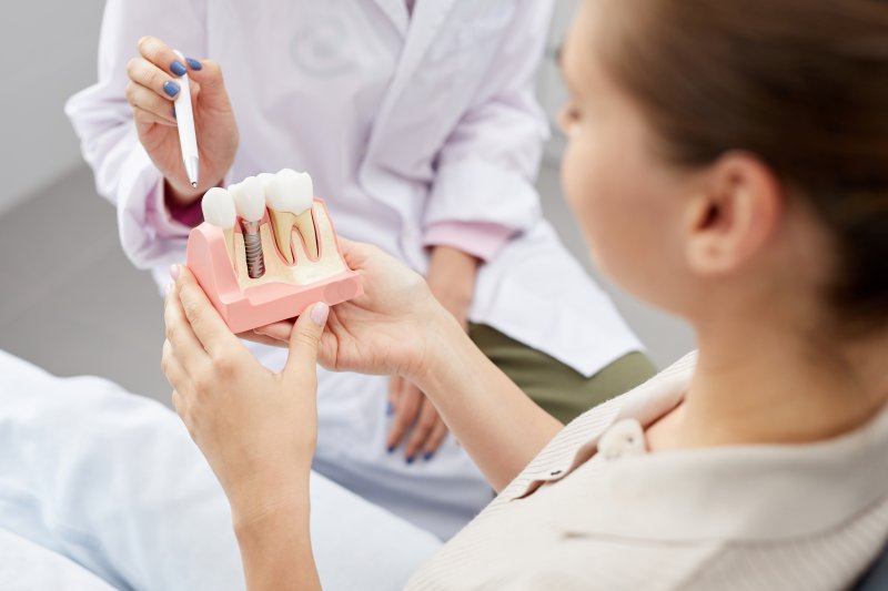 A dentist explaining how dental implants are safe