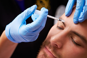 Man getting a BOTOX injection in his forehead