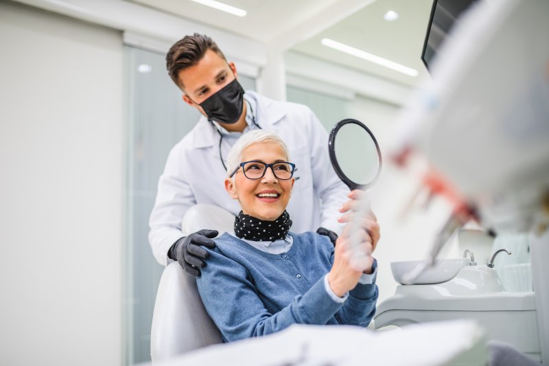 A smiling senior woman receiving dental care
